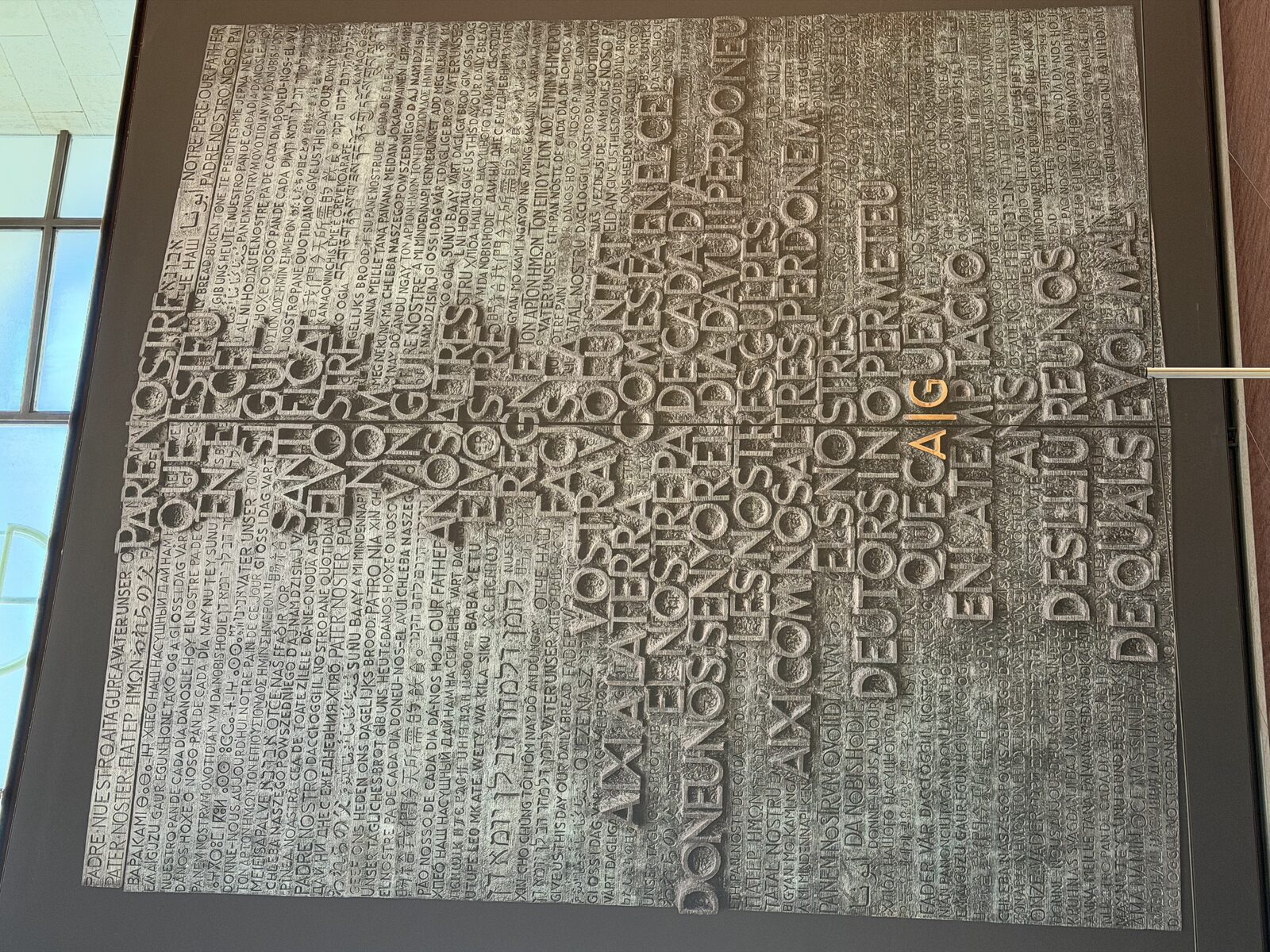 A large multilingual sculptural art installation of the Lord's Prayer, photographed during Barclay Barrios' travels.